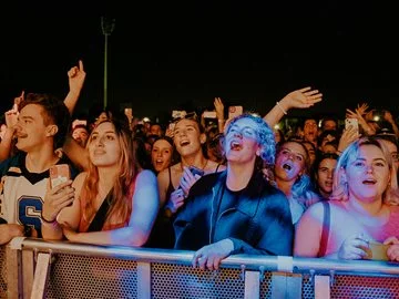 Young people singing along to a band at Hyperfest