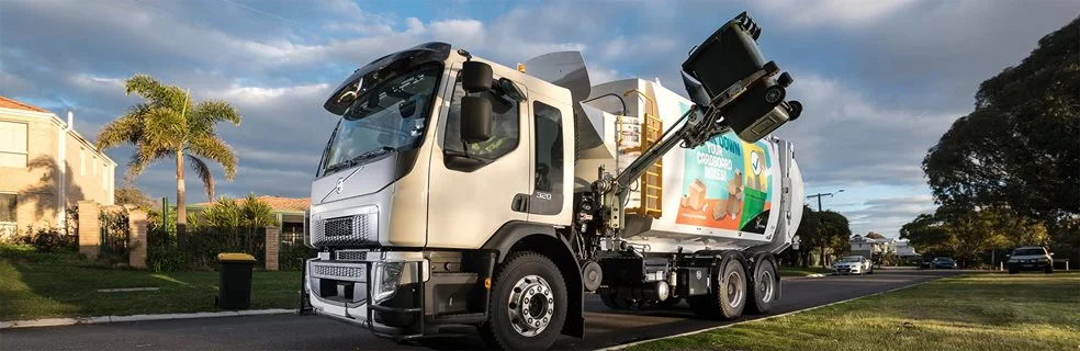 A recycling truck collecting a recycling bin