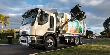 A recycling truck collecting a recycling bin
