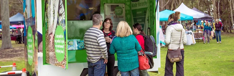 A City worker talks to locals about waste and recycling