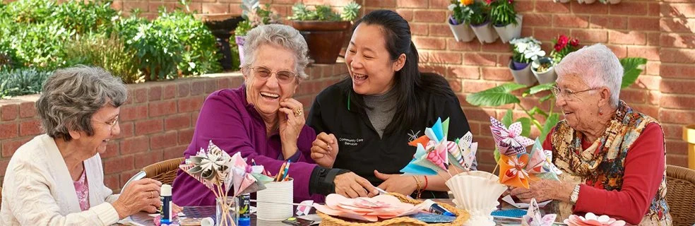 Laughing seniors at Swan Caring with a City worker