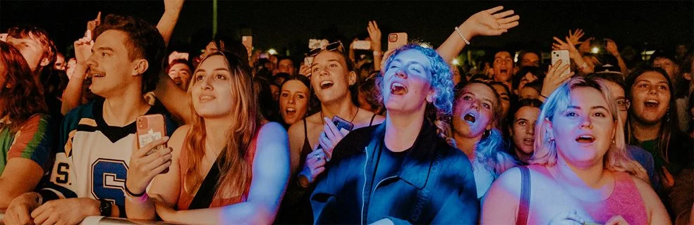 Young people singing along to a band at Hyperfest